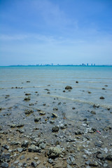 Stone courtyard on the public beach,Beautiful seascape with natural stone yard on beach against cloudy sky,Rocky shore at the seacoast with seascape and blue sky,