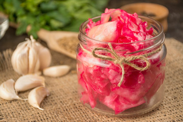Salad Cabbage with Beetroot in a small jar. Homemade food. Sour food. Pickled vegetables. Vegetarian vegan food. Side view