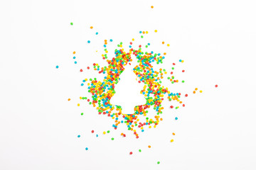 Christmas tree shape and multicolored decorations on a light background. Banner. Christmas, New Year concept. Minimalism. Flat lay, top view