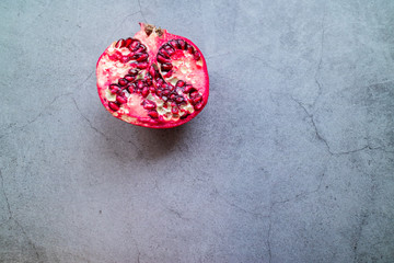 Isolated pomegranate on concrete background.