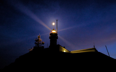moon over a lighthouse