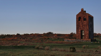 Winter sunset empty Cornish mine engine-house on Bodmin Moor