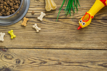 Dog food selection on wooden background with copy space, top view