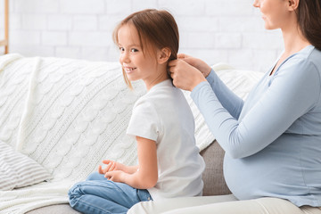 Close up of happy little girl spending time with mom