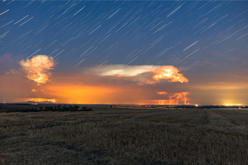 Storm and star trails at night in the countryside of time lapse