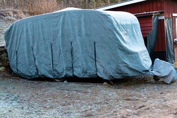 Caravan with a protective cover for winter.