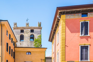 Colorful houses and small castle in the streets of Garda village