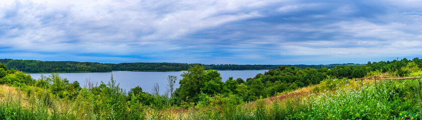 Fototapeta na wymiar Landscape with lake and blue sky. Panoramic top view of the lake with cloudy sky after sunset.