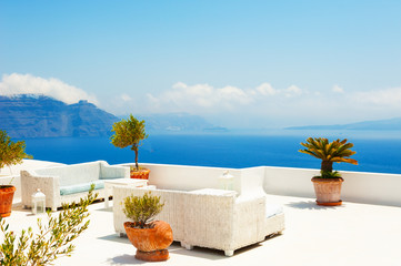 White architecture on Santorini island, Greece. Flowers on the terrace with sea view