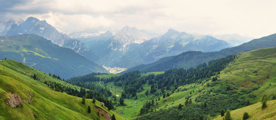 Fototapeta na wymiar View of mountains and Canazei village from Sella pass, Dolomites Alps, Italy, Europe