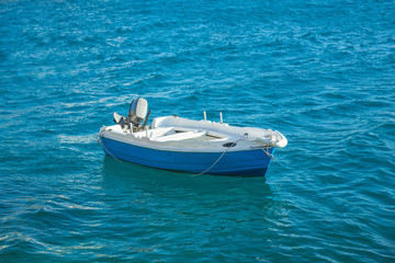 small fishing blue white boat in turquoise sea