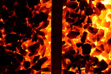  The texture of burning coal anthracite is divided in half by a steel product.