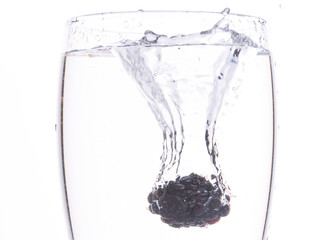 Blackberry fruit splashing into water