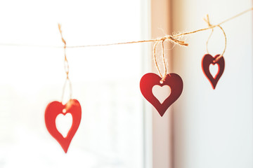 Decoration for Valentine's Day with ornaments in the form of hearts on a branch.
