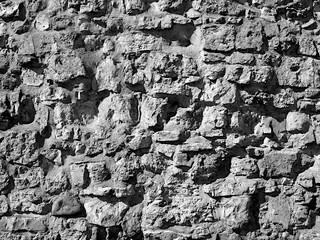 Masonry stone wall texture, background in black and white.