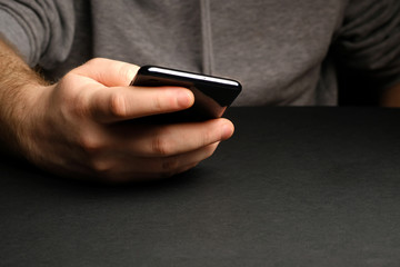 Close up of a man using mobile smart phone. Smartphone in male hands