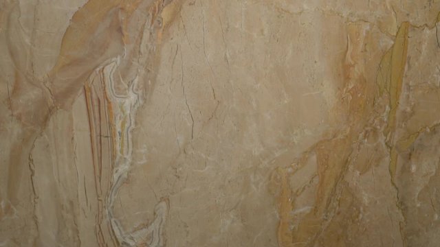 Close-up beautiful stone marble in beige tones solid surface in a modern design for finishing the kitchen, bathroom, interior decoration. Camera slide