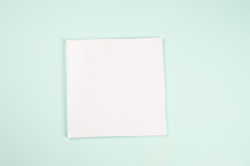 book on blue paper in a printing house, photobook with blank white cover