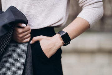 Fashionable details white sleeves. Details of women's clothing. The woman in pants and shirt. Details of everyday elegant look. Model wearing casual outfit. Summer, spring or fall street look.