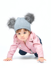 A baby dressed in a pink jacket