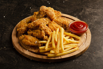 Fried chicken wings, french fries and ketchup sauce