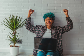 young girl or student at home with laptop celebrating success