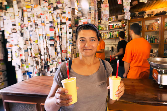 woman with typical drink in traditional tavern