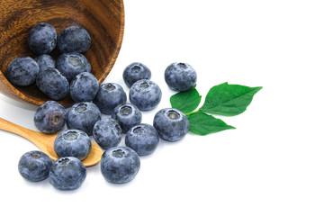 group of blueberry fresh fruit on wooden bowl spoon with green leave. Isolated on white background