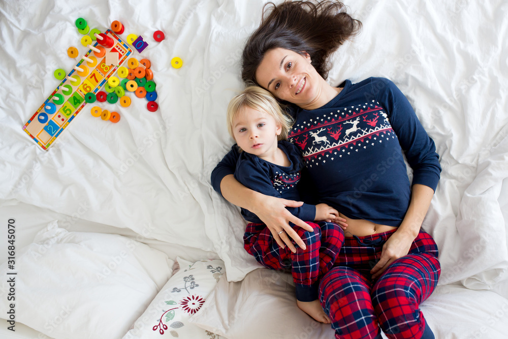 Sticker Nice sleepy morning in bed, mom and toddler child, boy, playing, kissing