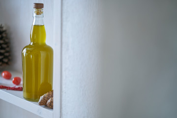 closeup kitchen shelf olive oil bottle pot parsley in mediterranean style, green yellow red vegetarian vegetable in sunny summer feeling,copy space blurred