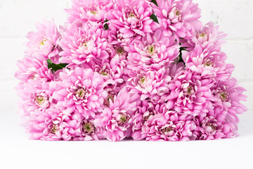 Pink flowers on white table. Romantic background for Valentine Day, Mothers Day or Birthday.