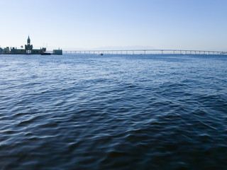 Naklejka premium Historical building in Ilha Fiscal, besides the famous Rio de Janeiro Niteroi Bridge, seen from inside Guanabara Bay,