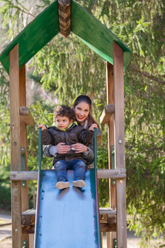 Beautiful Woman With Child In A Slide