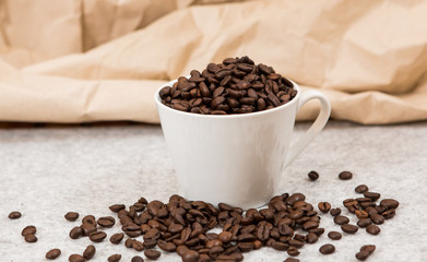 Roasted coffee beans in a caffe mug