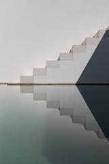 Reflection of concrete stairs in the pool