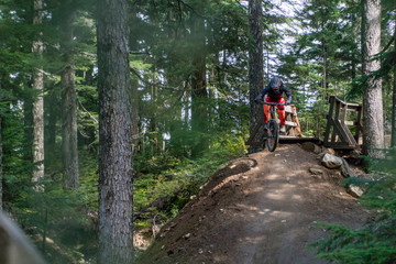 man jumping on whistler bike park trails