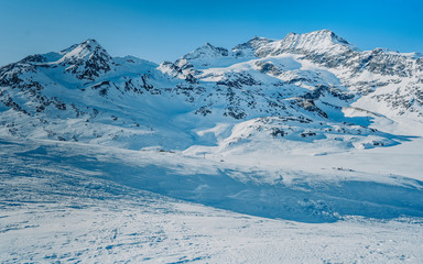 Beautiful Swiss Alps winter landscape during a bright sunny day. Winter outdoor activity in the...