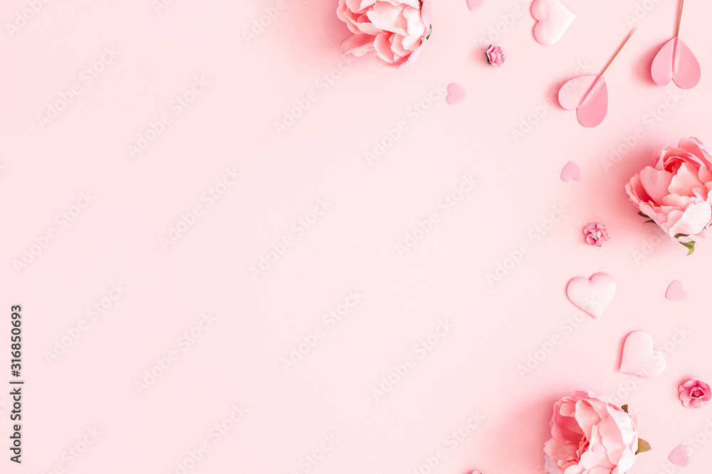 Wall mural Valentine's Day background. Pink flowers, envelope, hearts on pastel pink background. Valentines day concept. Flat lay, top view, copy space