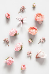 Flowers composition. White and pink flowers on pastel gray background. Valentines day, mothers day, womens day concept. Flat lay, top view