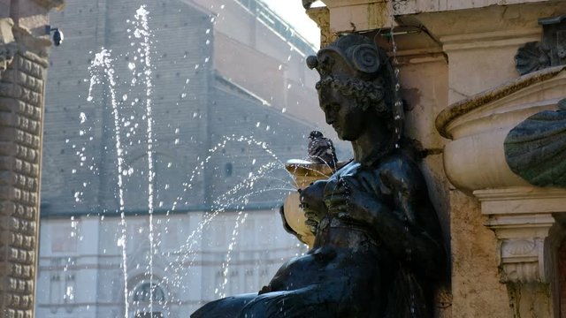 Bologna local landmark of Emilia Romagna region of Italy - detail of fountain of Neptune statue or Fontana del Nettuno with water spouts from woman breasts