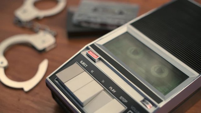 Police detective investigator playing audio cassette with recorded interview