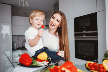 Family in a kitchen. Beautiful mother with little son
