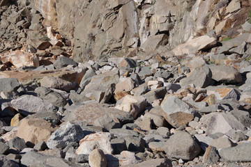 Close-up view of fallen heavy rocks at a steep mountain side
