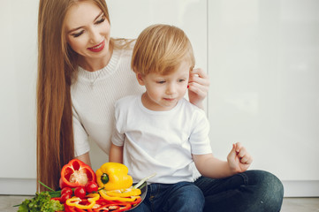 Family in a kitchen. Beautiful mother with little son