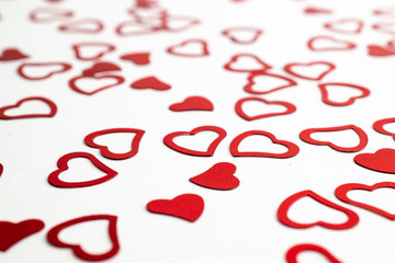 Valentines day red Heart shape confetti splash on white. Symbol of love.