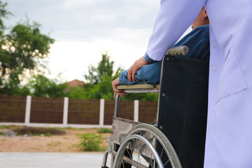 Obraz premium Physical therapist Disabled wheelchair with professional care.concept