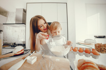 Family in a kitchen. Beautiful mother with little son