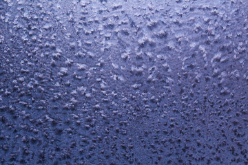 frosty patterns on the window glass in winter