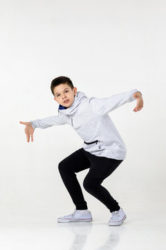 Little Hip-hop Boy Dancing On White Studio Background. Sports Dance. Modern Style