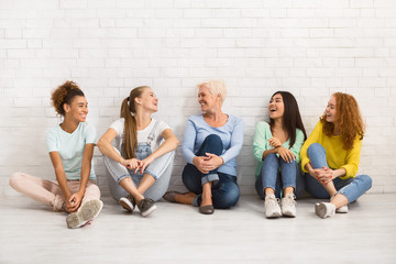 Diverse Women Sitting On Floor Talking And Smiling Indoor - Powered by Adobe